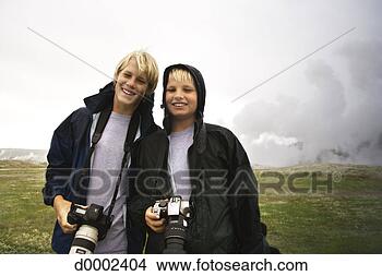 Stock Photo - two boys posing 
in front of geyser. 
fotosearch - search 
stock photos, 
pictures, images, 
and photo clipart