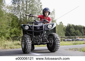 Stock Photography - boy on atv. fotosearch 
- search stock 
photos, pictures, 
images, and photo 
clipart