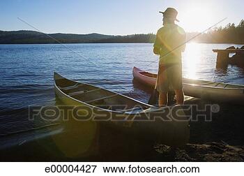 Picture - man by canoes. 
fotosearch - search 
stock photos, 
pictures, images, 
and photo clipart