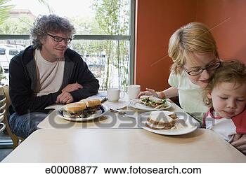 Picture - family eating 
lunch in restaurant. 
fotosearch - search 
stock photos, 
pictures, images, 
and photo clipart