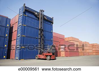 Stock Photography - forklift lifting 
cargo containers. 
fotosearch - search 
stock photos, 
pictures, images, 
and photo clipart