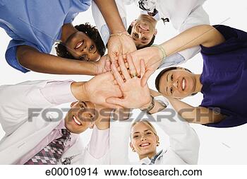 Stock Photo - huddled healthcare 
workers. fotosearch 
- search stock 
photos, pictures, 
images, and photo 
clipart