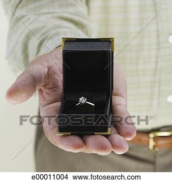 Stock Photo - man holding engagement 
ring in box. fotosearch 
- search stock 
photos, pictures, 
images, and photo 
clipart