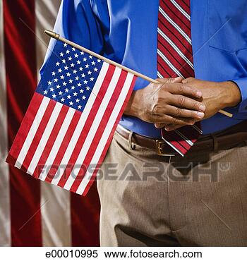 Stock Image - man holding small 
american flag. 
fotosearch - search 
stock photos, 
pictures, images, 
and photo clipart