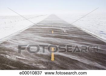 Picture - snw blowing over 
road. fotosearch 
- search stock 
photos, pictures, 
images, and photo 
clipart