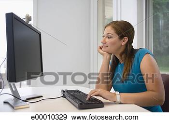 Stock Photograph - teenage girl using 
computer with 
webcam. fotosearch 
- search stock 
photos, pictures, 
images, and photo 
clipart