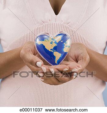 Picture - woman holding 
heart-shaped world. 
fotosearch - search 
stock photos, 
pictures, images, 
and photo clipart