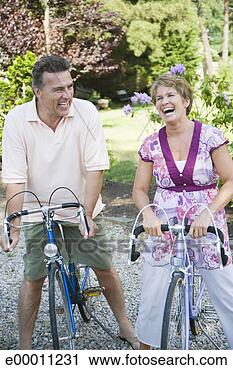 Stock Photography - couple riding 
bicycles. fotosearch 
- search stock 
photos, pictures, 
images, and photo 
clipart