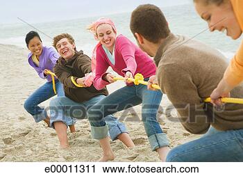 Stock Photography - friends in tug-of-war 
on beach. fotosearch 
- search stock 
photos, pictures, 
images, and photo 
clipart