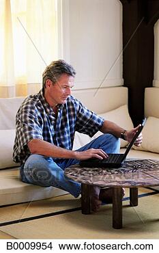 Stock Photo - caucasian, couch, 
furniture, grey 
hair, home, laptop, 
male. fotosearch 
- search stock 
photos, pictures, 
images, and photo 
clipart