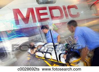 Stock Photo - composite of two 
medics loading 
a patient on a 
stretcher into 
the. fotosearch 
- search stock 
photos, pictures, 
images, and photo 
clipart