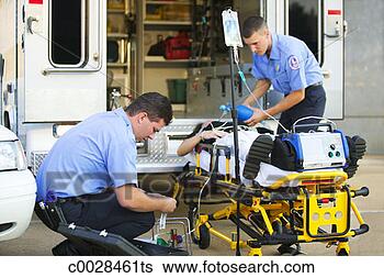 Stock Photo - two medics aid 
a patient on a 
stretcher at the 
rear of the ambulance. 
fotosearch - search 
stock photos, 
pictures, images, 
and photo clipart