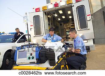 Stock Photo - two medics aid 
a patient on a 
stretcher at the 
rear of the ambulance. 
fotosearch - search 
stock photos, 
pictures, images, 
and photo clipart