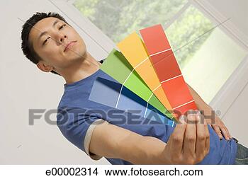 Stock Photo - man holding paint 
samples. fotosearch 
- search stock 
photos, pictures, 
images, and photo 
clipart