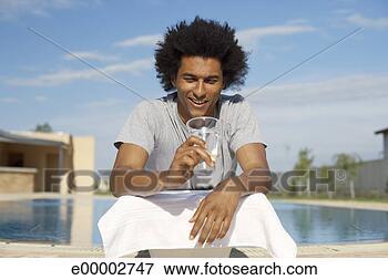 Picture - man lying on diving 
board, looking 
at glass of water. 
fotosearch - search 
stock photos, 
pictures, images, 
and photo clipart
