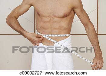 Picture - man measuring 
his waist with 
tape measure. 
fotosearch - search 
stock photos, 
pictures, images, 
and photo clipart