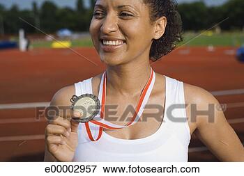 Picture - young athlete 
holding medal. 
fotosearch - search 
stock photos, 
pictures, images, 
and photo clipart