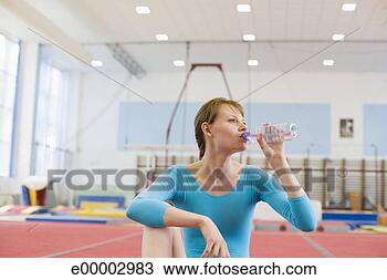 Stock Photo - young gymnast 
drinking bottled 
water. fotosearch 
- search stock 
photos, pictures, 
images, and photo 
clipart
