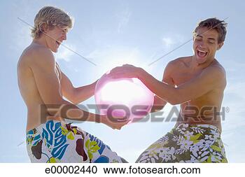 Stock Photography - men fighting over 
beach ball on 
beach. fotosearch 
- search stock 
photos, pictures, 
images, and photo 
clipart