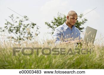 Stock Photo - man in field with 
laptop. fotosearch 
- search stock 
photos, pictures, 
images, and photo 
clipart