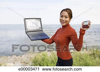 Stock Photography - woman with laptop 
and pda. fotosearch 
- search stock 
photos, pictures, 
images, and photo 
clipart