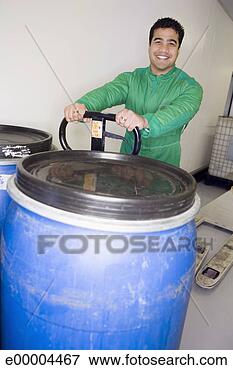 Picture - industrial worker 
moving barrels. 
fotosearch - search 
stock photos, 
pictures, images, 
and photo clipart
