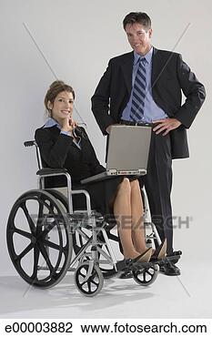 Stock Photo - woman in wheelchair 
with laptop and 
businessman. fotosearch 
- search stock 
photos, pictures, 
images, and photo 
clipart