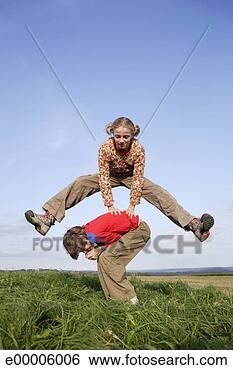 Stock Photo - girl leaping over 
boy. fotosearch 
- search stock 
photos, pictures, 
images, and photo 
clipart