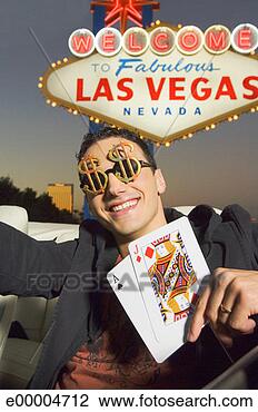 Stock Photo - high roller holding 
playing cards 
by las vegas sign. 
fotosearch - search 
stock photos, 
pictures, images, 
and photo clipart