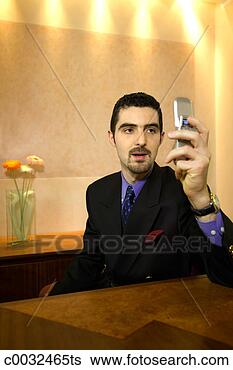 Stock Photo - businessman using 
cell phone. fotosearch 
- search stock 
photos, pictures, 
images, and photo 
clipart