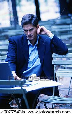 Stock Photo - man using laptop 
in cafe. fotosearch 
- search stock 
photos, pictures, 
images, and photo 
clipart