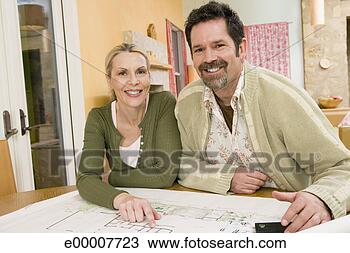 Stock Photo - couple looking 
at house plans. 
fotosearch - search 
stock photos, 
pictures, images, 
and photo clipart