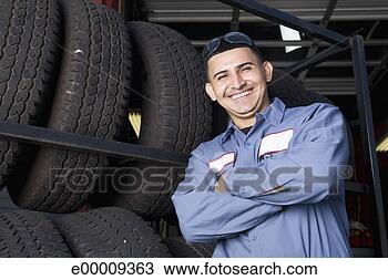 Stock Photo - smiling mechanic 
with tires. fotosearch 
- search stock 
photos, pictures, 
images, and photo 
clipart
