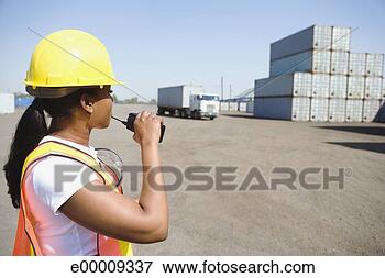 Picture - worker with walkie 
talkie in shipping 
yard. fotosearch 
- search stock 
photos, pictures, 
images, and photo 
clipart