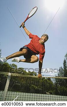 Stock Photo - tennis player 
leaping over net. 
fotosearch - search 
stock photos, 
pictures, images, 
and photo clipart