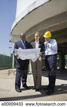 Stock Photo - executives looking 
at plans. fotosearch 
- search stock 
photos, pictures, 
images, and photo 
clipart