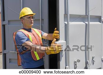 Stock Photography - worker closing 
door of shipping 
container. fotosearch 
- search stock 
photos, pictures, 
images, and photo 
clipart