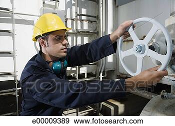 Stock Photograph - worker turning 
valve. fotosearch 
- search stock 
photos, pictures, 
images, and photo 
clipart