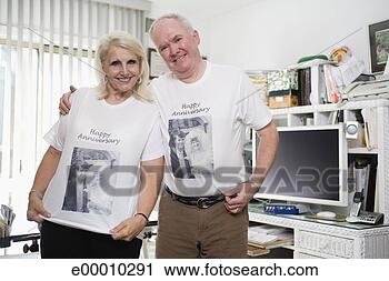 Stock Photography - senior couple 
wearing anniversary 
shirts. fotosearch 
- search stock 
photos, pictures, 
images, and photo 
clipart