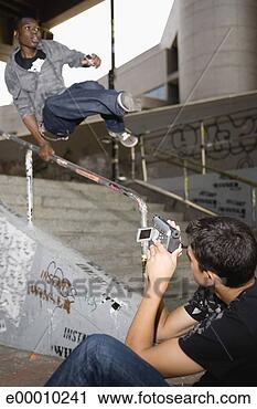 Stock Photography - teen filming jumping 
man. fotosearch 
- search stock 
photos, pictures, 
images, and photo 
clipart