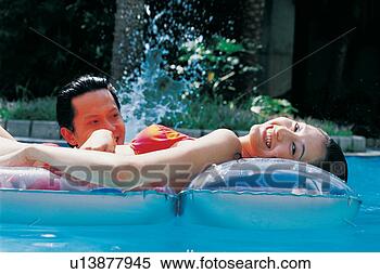 Stock Image - asian, black hair, 
bikini, romance, 
asian ethnicity. 
fotosearch - search 
stock photos, 
pictures, images, 
and photo clipart