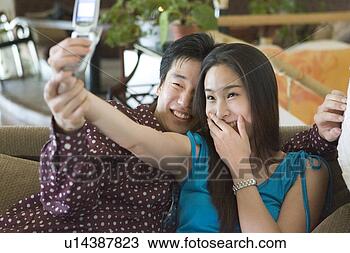 Stock Photo - mobilphone, orient, 
woman, couple, 
black hair, couple. 
fotosearch - search 
stock photos, 
pictures, images, 
and photo clipart