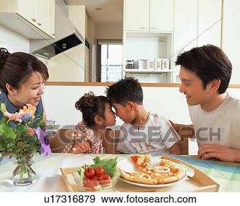 Stock Photograph - a brother and 
a sister having 
an eye contact 
while their parents 
look. fotosearch 
- search stock 
photos, pictures, 
images, and photo 
clipart