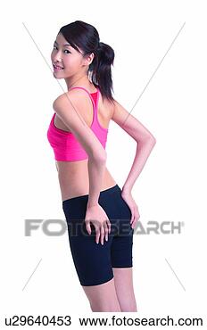 Stock Photo - young woman in 
sporty wear, standing, 
three quarter 
length. fotosearch 
- search stock 
photos, pictures, 
images, and photo 
clipart