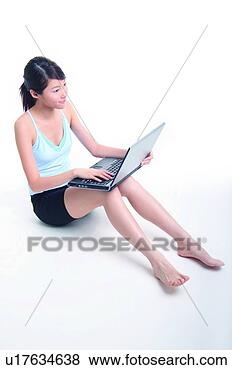 Banco de Imagem - jovem,  mulher, 
 sentando,  usando, 
 caderno. fotosearch 
- busca de fotos, 
imagens e clipart