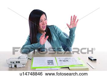 Stock Photo - young woman working, 
rejecting something. 
fotosearch - search 
stock photos, 
pictures, images, 
and photo clipart