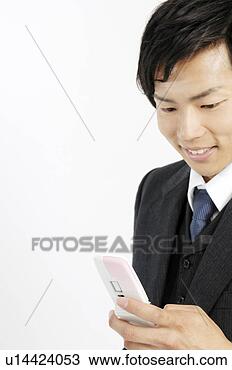 Stock Photo - businessman checking 
the email of the 
cell phone. fotosearch 
- search stock 
photos, pictures, 
images, and photo 
clipart