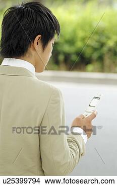 Stock Photo - businessman checking 
the email of the 
cell phone. fotosearch 
- search stock 
photos, pictures, 
images, and photo 
clipart