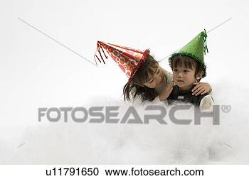 Stock Photography - brother and sister 
wearing party 
hats. fotosearch 
- search stock 
photos, pictures, 
images, and photo 
clipart