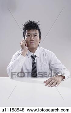 Stock Photo - young man on the 
phone. fotosearch 
- search stock 
photos, pictures, 
images, and photo 
clipart